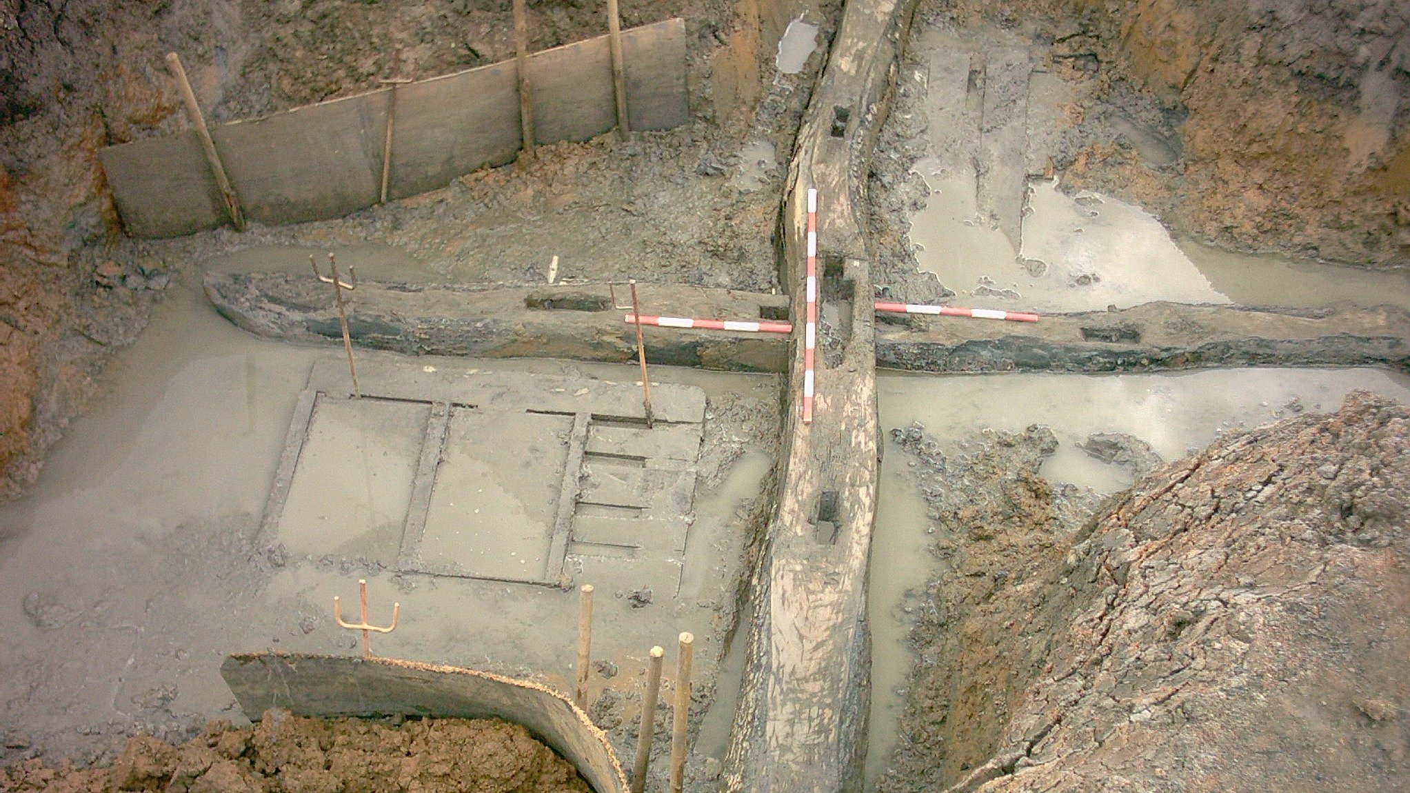 Ausgrabung in Lankenau 2008. Sich kreuzende hölzerne Balken, die den Unterbau einer Bockwindmühle bilden.